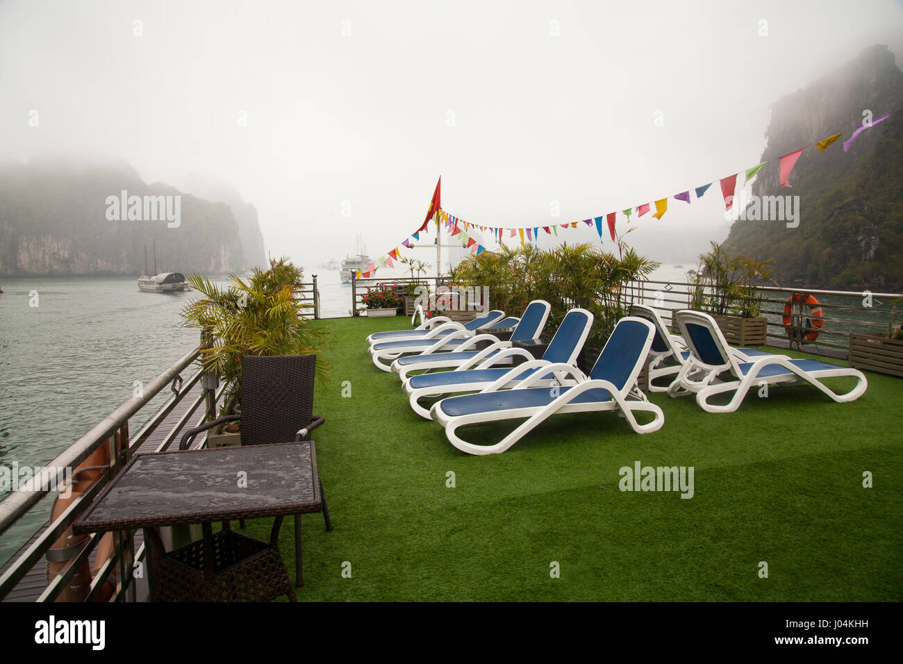 Boat upper deck with blue beach chairs, empty, no people, overlooking