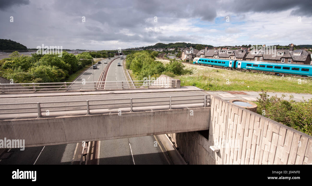 Conwy, Wales, UK - June 16, 2012: An Arriva Trains Wales Class 175 diesel passenger train runs along the Llandudno branch railway, beside the A55 Nort Stock Photo