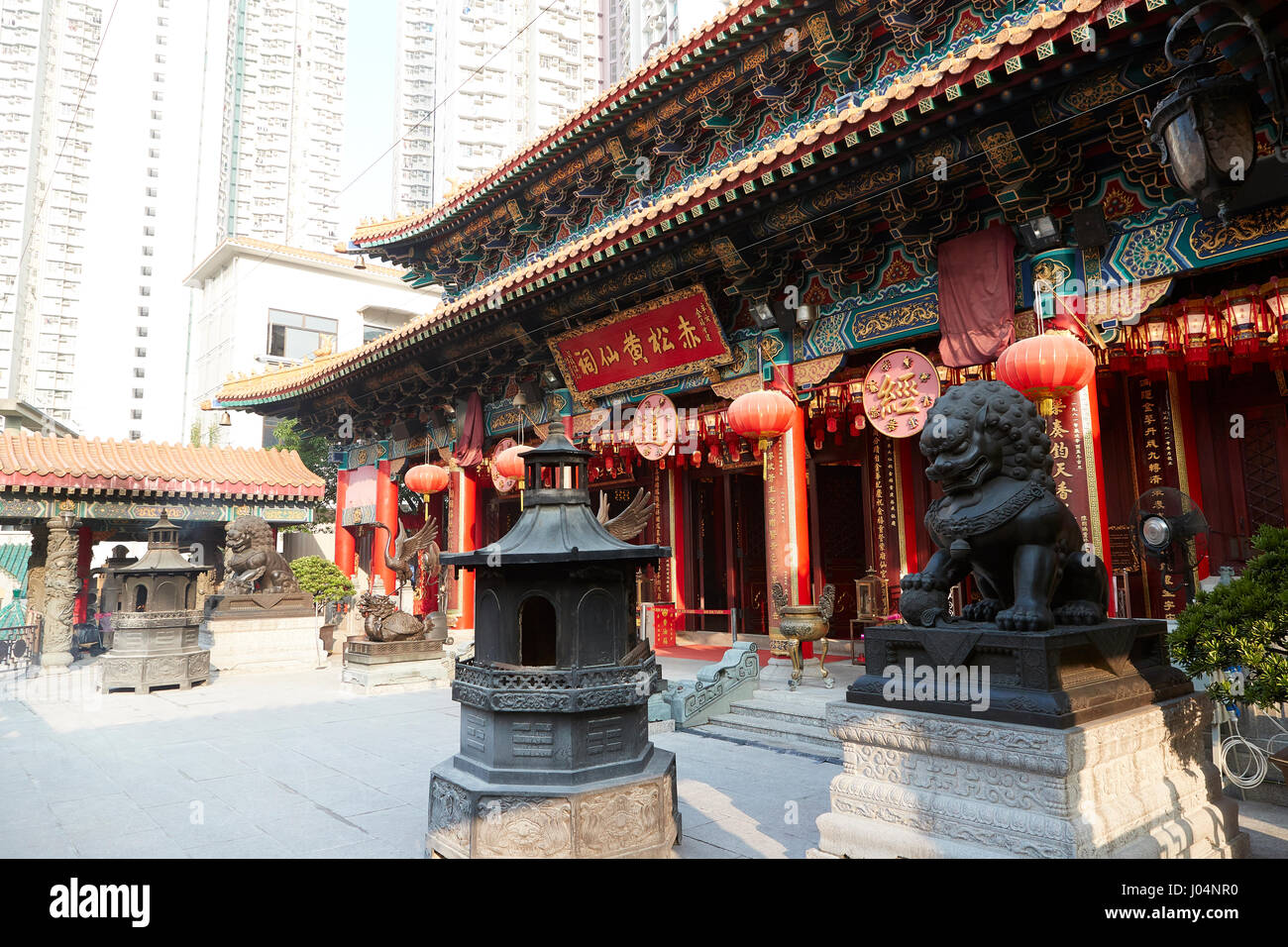 High Rise Apartment Buildings Contrast With The Traditional Chinese Buddhist Wong Tai Sin Temple, Hong Kong. Stock Photo