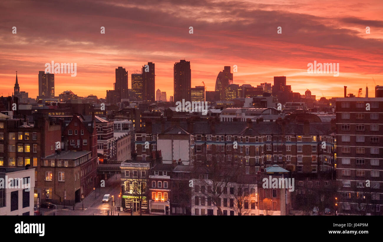 London, England, UK - January 10, 2011: Skyscrapers of the City of London are silhouetted against the sunrise seen from Clerkenwell. Stock Photo
