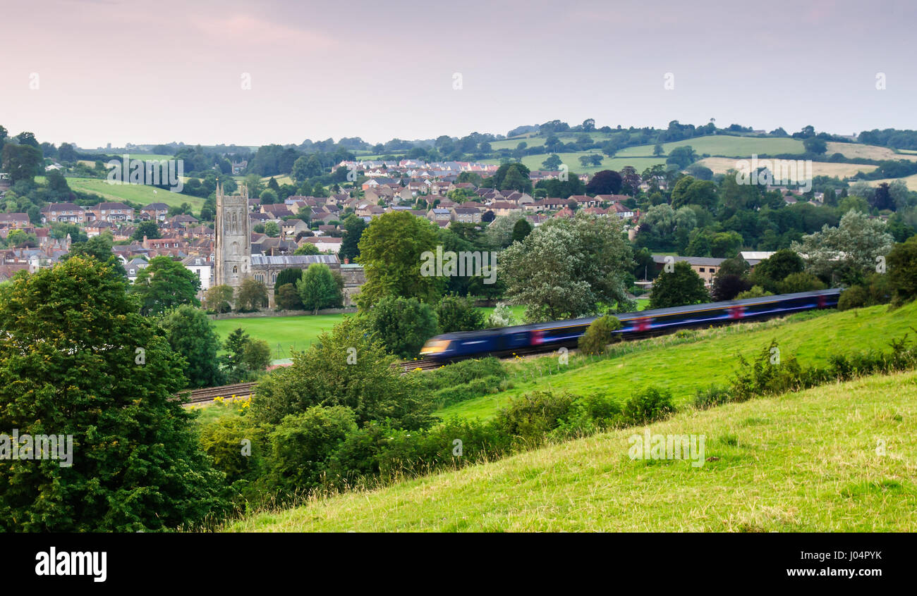 Bruton, England, UK - July 26, 2012: A First Great Western Intercity 125 high speed passenger train passes the church and town of Bruton, Somerset. Stock Photo