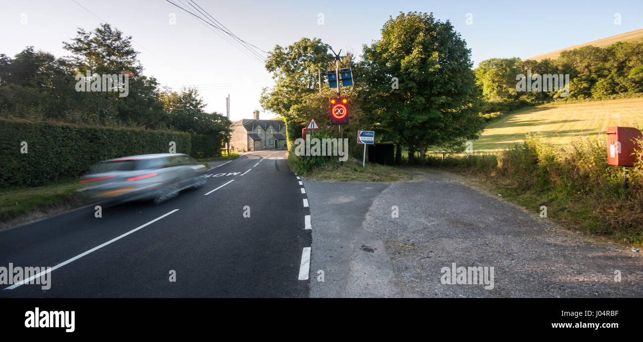 Shaftesbury, England, UK - July 28, 2012: Traffic rushes through Melbury Abbas village in rural north Dorset, activating an electronic speed limit sig Stock Photo