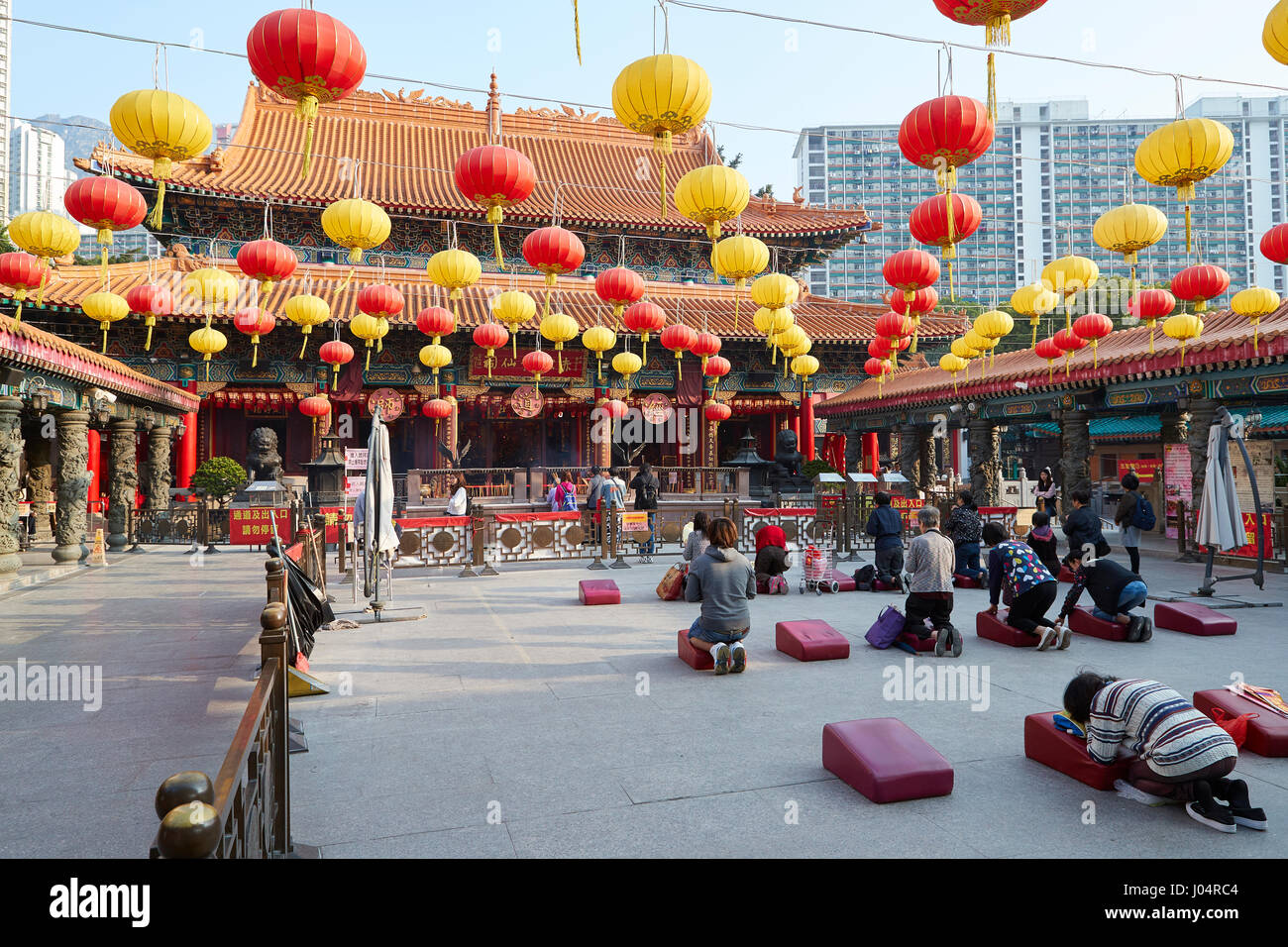 Chinese People Worshipping At The Buddhist Wong Tai Sin Temple, Hong Kong. Stock Photo