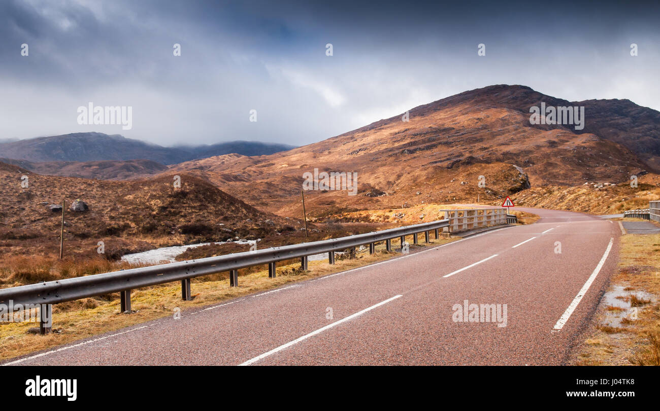 The A896 road winds through the valley of Glen Torridon, between the Torridon Hills mountains, in the north west Highlands of Scotland. Stock Photo