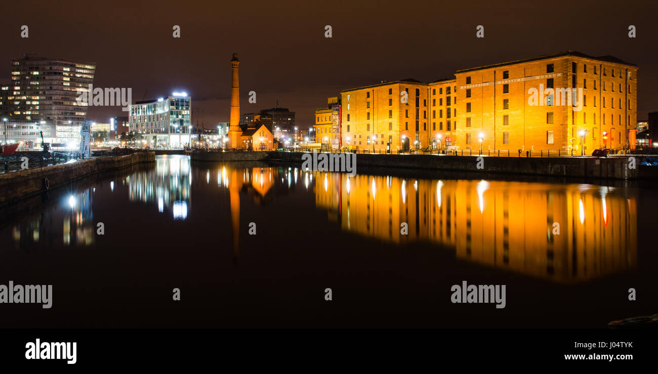 Liverpool, England, UK - November 4, 2014: The pump house and warehouses of the historic Albert Dock complex are reflected in Canning Dock, Liverpool. Stock Photo