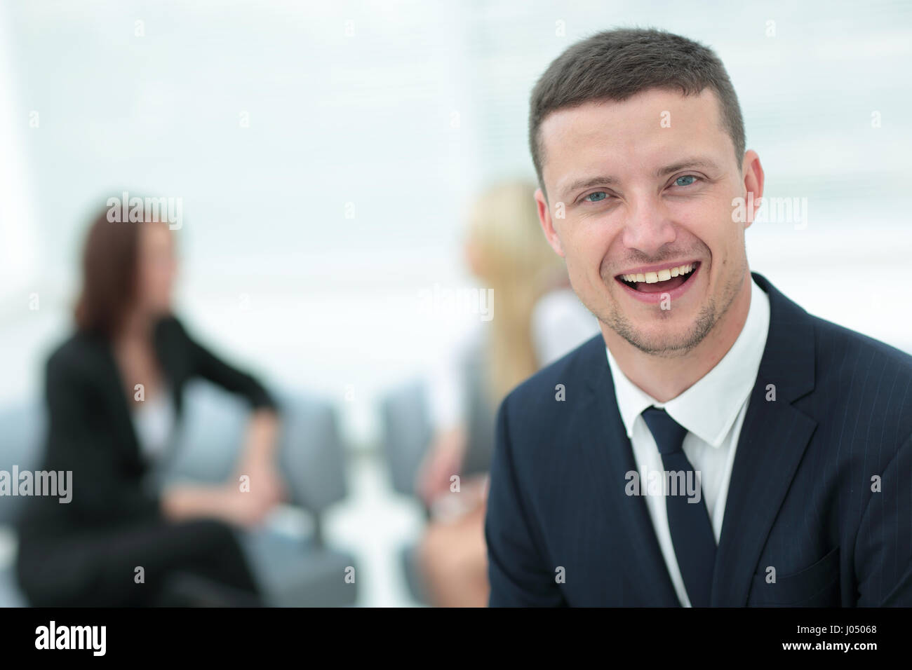 Portrait of a smiling business man with colleagues working in the ...