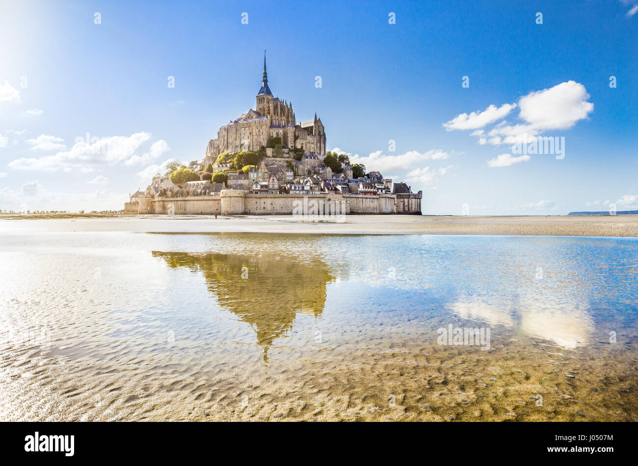 Panoramic view of famous Le Mont Saint-Michel tidal island on a sunny day with blue sky and clouds, Normandy, northern France Stock Photo