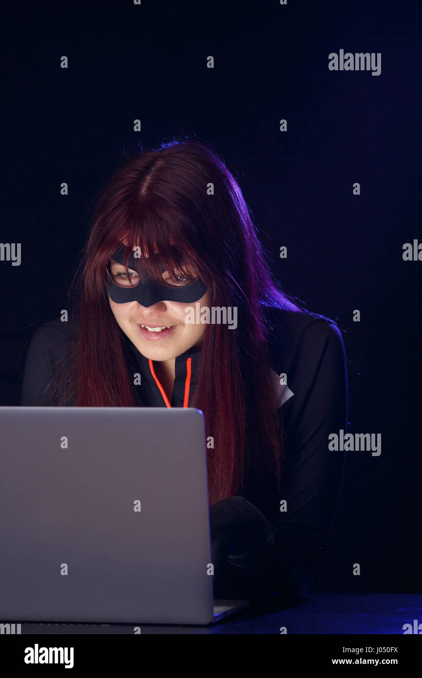 Thief in mask steals information Stock Photo - Alamy