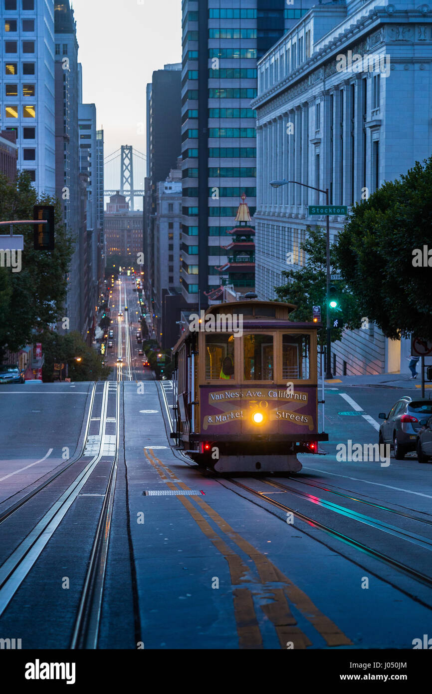 Classic view of historic Cable Car riding on famous California Street in beautiful early morning twilight before sunrise in summer, San Francisco, USA Stock Photo
