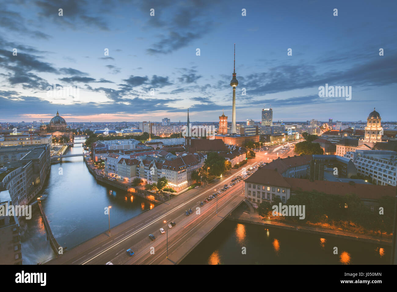 Classic aerial view of Berlin skyline with famous TV tower and Spree river in beautiful post sunset twilight during blue hour at dusk Stock Photo