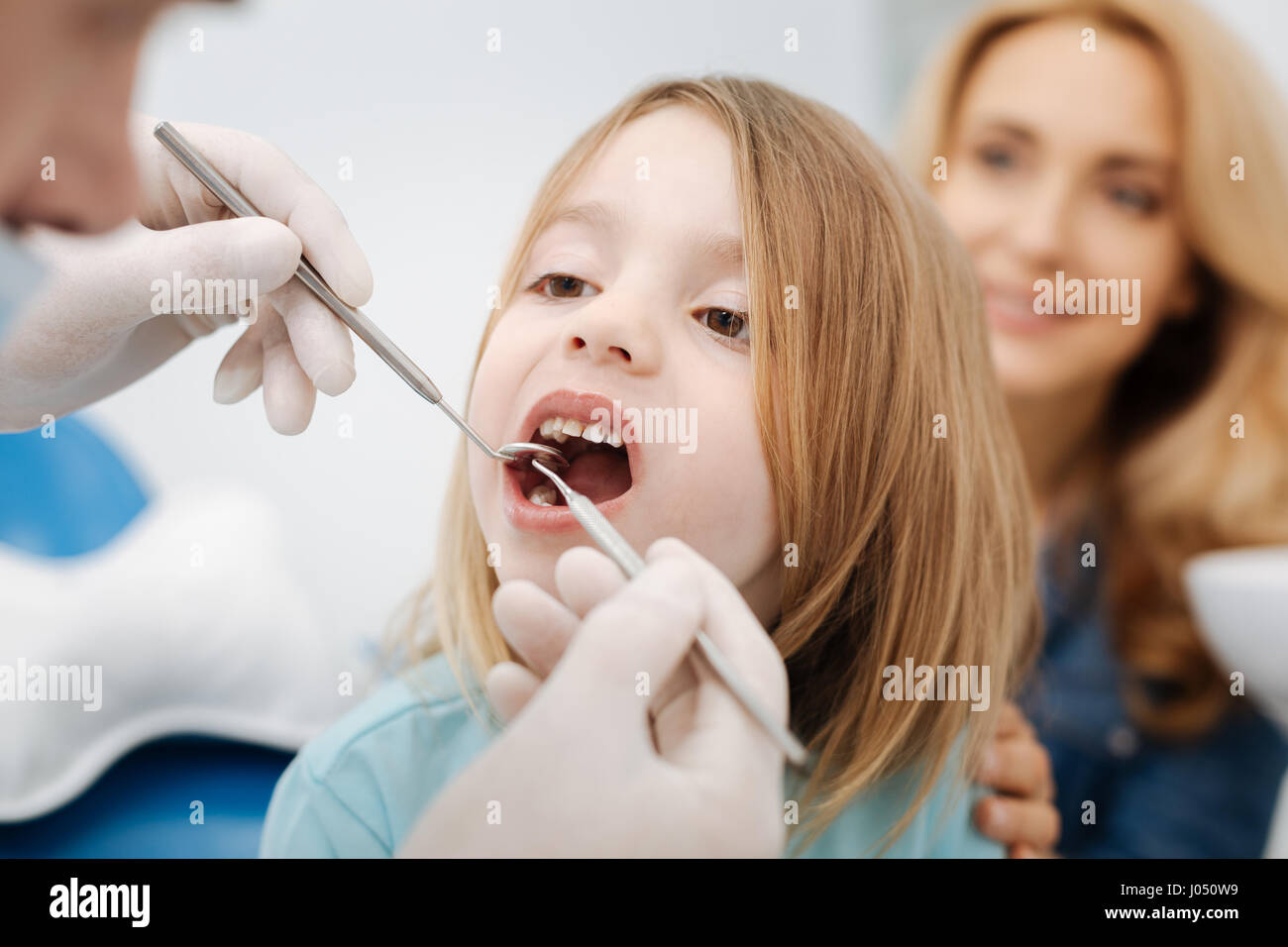Gentle pediatric dentist doing a checkup Stock Photo