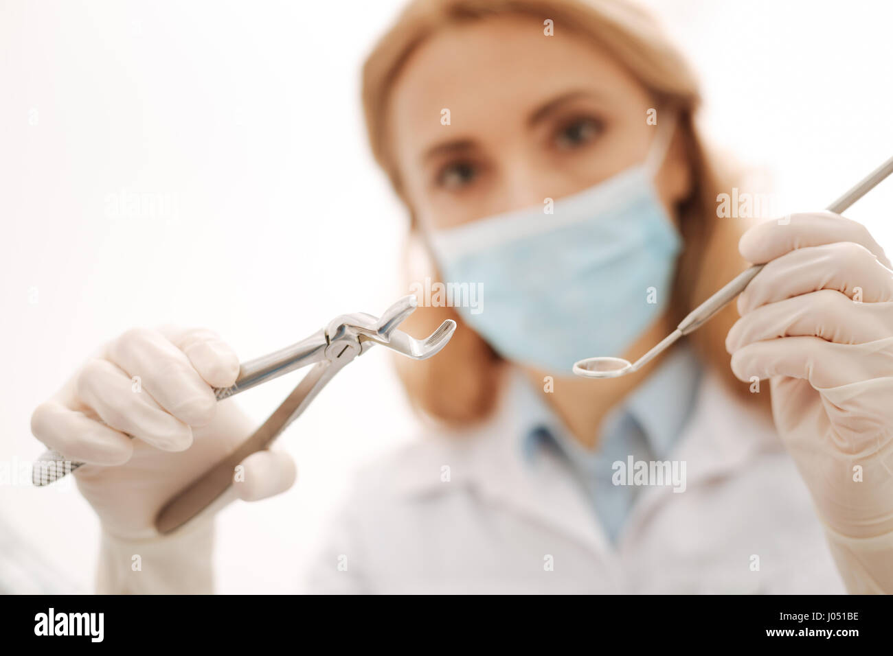 Busy engaged focused specialist holding a set of sterile tools Stock Photo