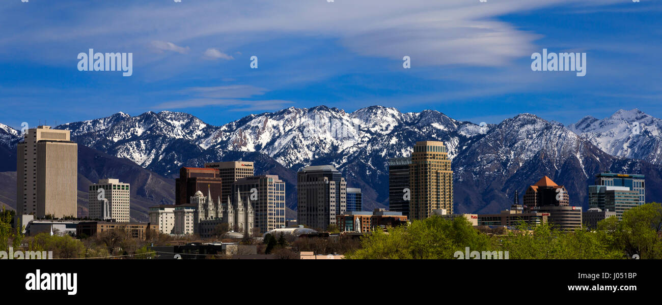 This is a springtime view of the downtown buildings of Salt Lake City, Utah, USA with the snowcapped Wasatch Mountains as the backdrop. Stock Photo