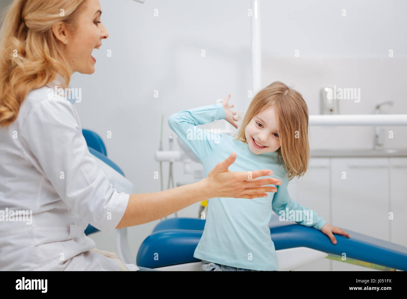 Active energetic child having fun with her dentist Stock Photo