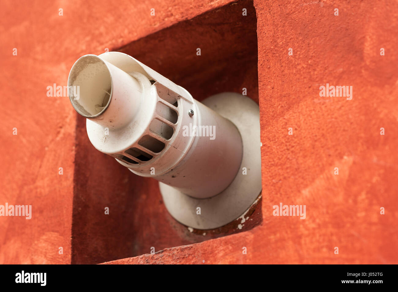 Chimney for smoke outlet on the wall. Forced circulation airtight double boiler. Outdoor flue and air intake. Stock Photo