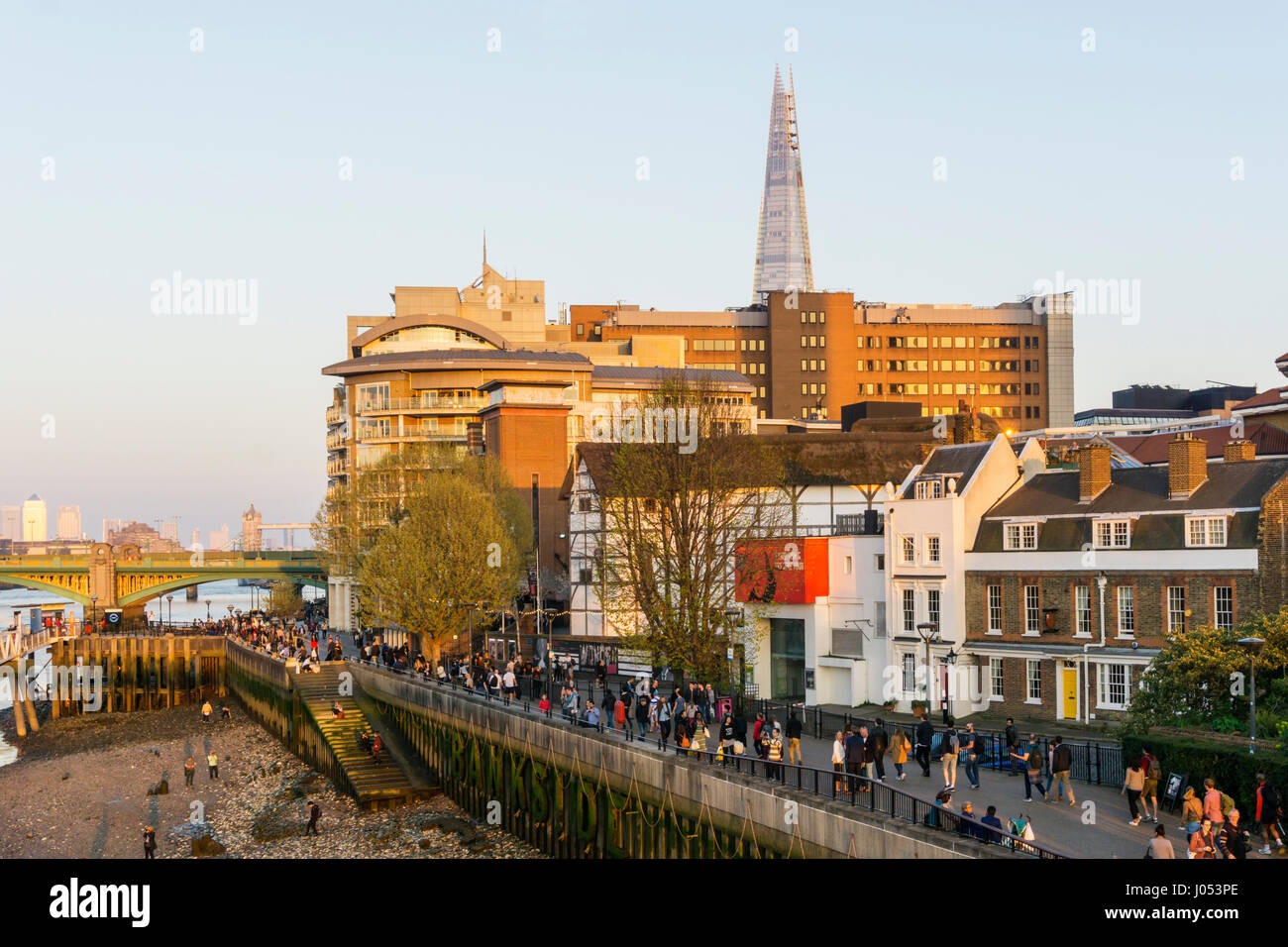 People enjoying a sunny evening on London's South Bank in front of the Globe Theatre with the Shard in the background. Stock Photo