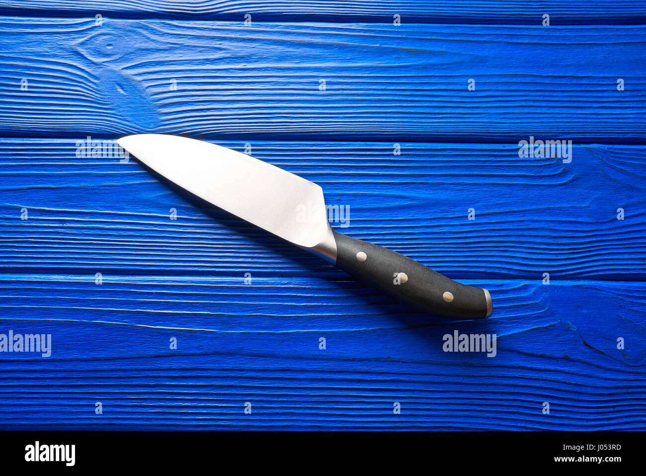 https://c8.alamy.com/comp/J053RD/chef-tools-black-knife-on-a-blue-wooden-background-J053RD.jpg