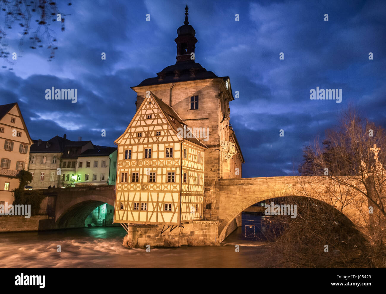 Classic panorama view of the famous old town hall of Bamberg with Regnitz river flowing in beautiful twilight at dusk, Oberfranken region, Bavaria Stock Photo