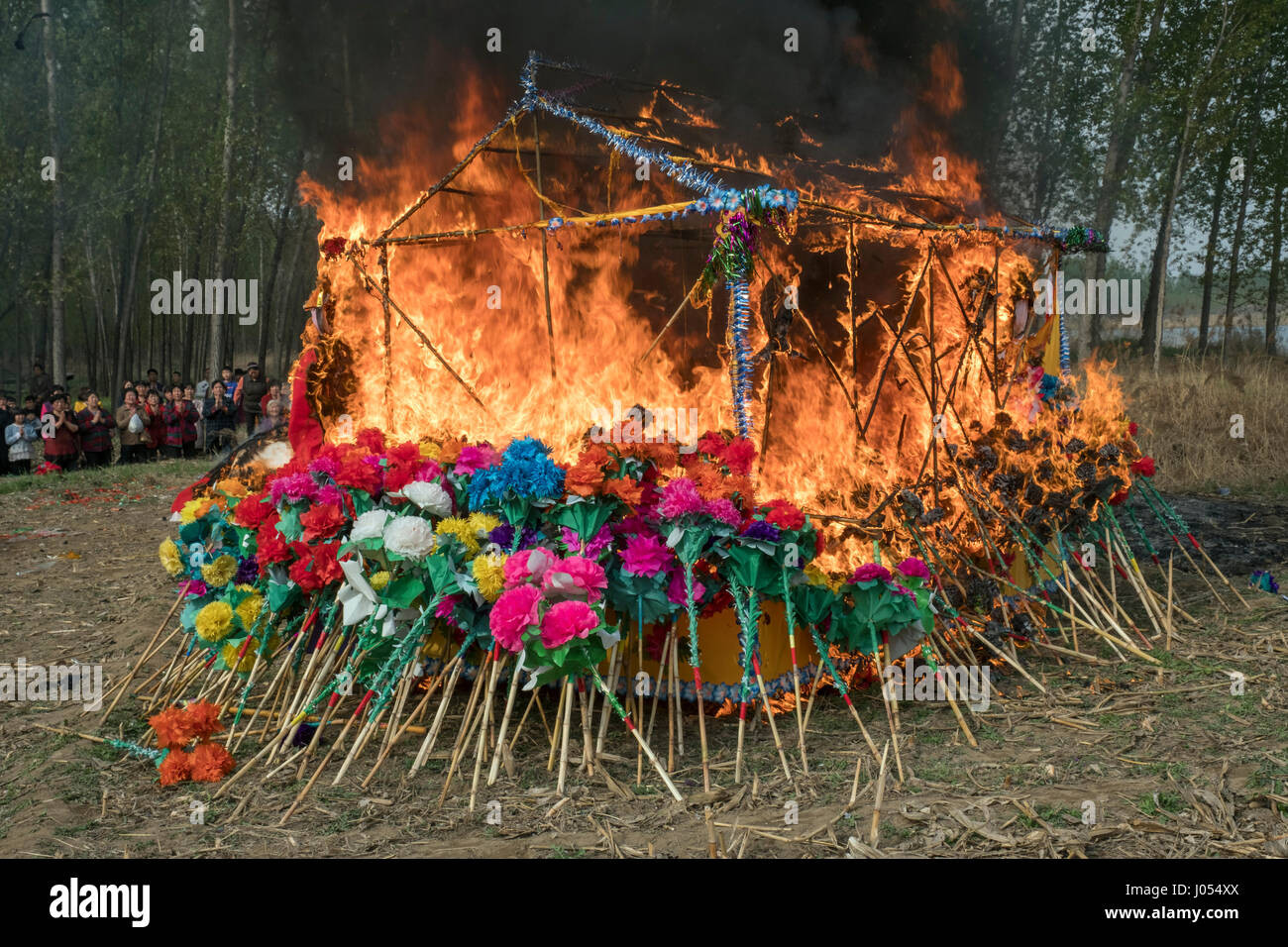 Local villagers burn up the shrine while attending an annual Taoism ceremony to celebrate the birthday of Bixia Yuanjun, known as the 'Lady of Mount Tai”, one of the most important Taoism goddesses in Northern China, in Liutong village, Rongcheng county, one of the three counties composing Xiongan New Area in Hebei Province, China on April 09, 2017. With Chinese government suddenly announced the location of the special economic zone (SEZ) which would effectively serve as an extension of capital Beijing one week ago, such ceremony of Liutong maybe the last one. Stock Photo