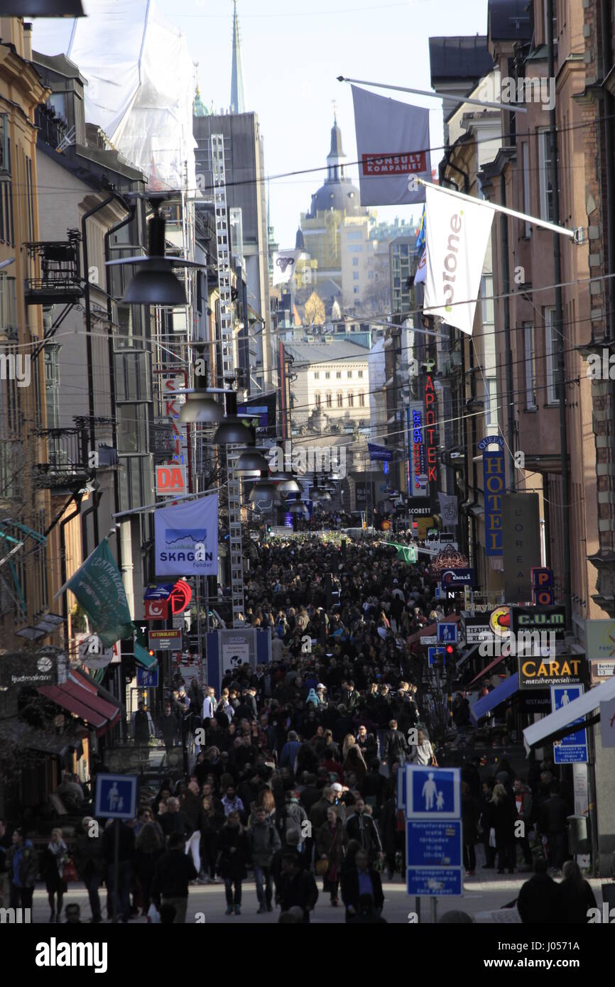 Drottninggatan (& Kammakargatan) street view in daytime, looking down to Stockholm's Ahlens shopping mall, marking the second turn to the left of the deadly route towards the city, where the  truck attacker terrorist left behind 5 dead people, one dead dog named Iggy and 16 people injured seriously. Stockholm city, Sweden. 9 April 2017. Stock Photo
