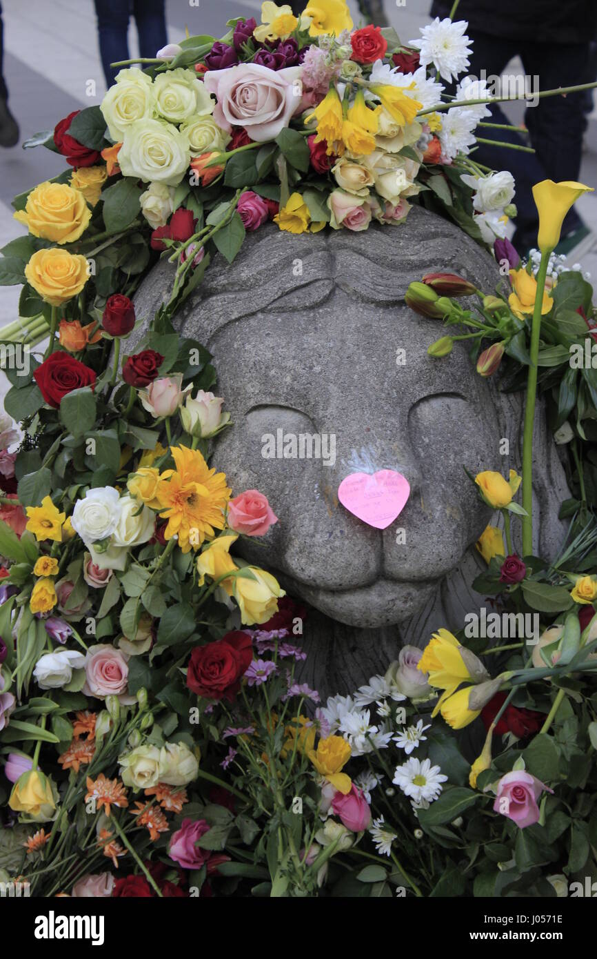 Closeup view of concrete barricade depicting a lion animal, covered with flowers in Drottninggatan street, near Ahlens shopping center, portraying the Swedish sympathy and mourn for the casualties of the 7 April Closeup view of concrete barricade depicting a lion animal, covered with flowers in Drottninggatan street, near Ahlens shopping center, portraying the Swedish sympathy and mourn for the casualties of the 7 April