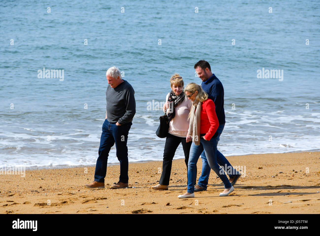 West Bay, Dorset, UK.  10th April 2017.  UK Weather.   Cooler temperatures at West Bay on the Dorset Jurassic Coast, with holiday makers swapping bikini's for fleeces and coats.  Photo Credit: Graham Hunt/Alamy Live News Stock Photo