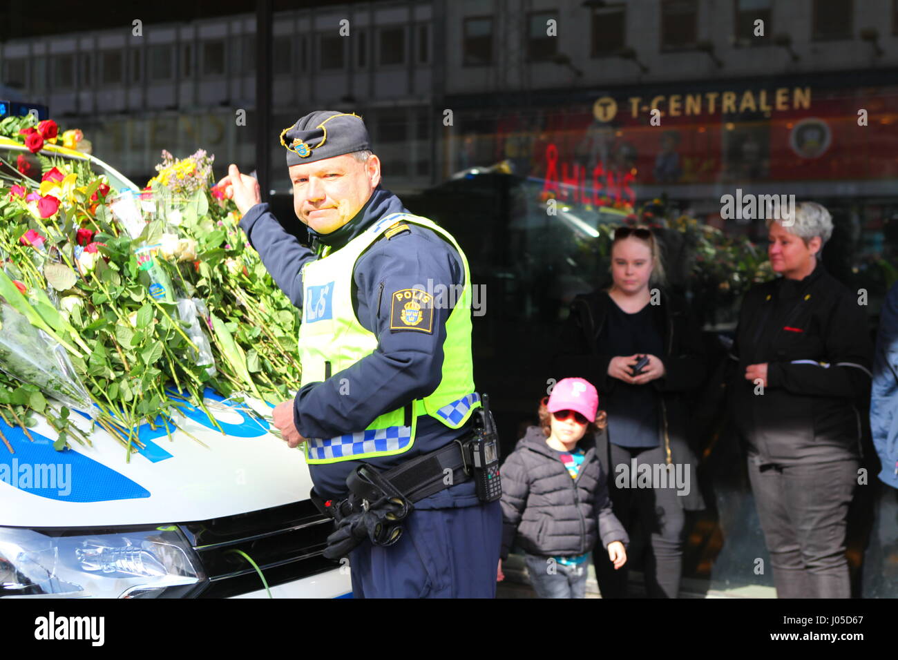Emotional scenes at the site of the Stockholm Truck Attack. People have come to lay flowers on a police car on the Sunday after the attack. Stock Photo