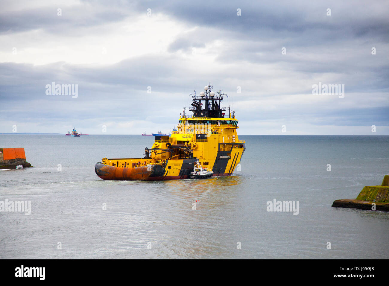 Aberdeen, Scotland, UK. 11th Apr, 2017. UK Weather. Cloudy overcast with light rain and gales expected as Njord Viking a TUG SUPPLY VESSEL leaves Aberdeen harbour for the north sea oilrigs. The Njord Viking  Offshore Supply Ship is a High Ice-classed AHTS vessel capable of operations in harsh environment offshore regions, as well as Arctic/Sub-Arctic operations. Credit: MediaWorldImages/Alamy Live News Stock Photo