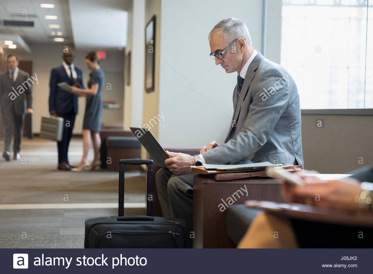 Male attorney using laptop in courthouse corridor Stock Photo Alamy