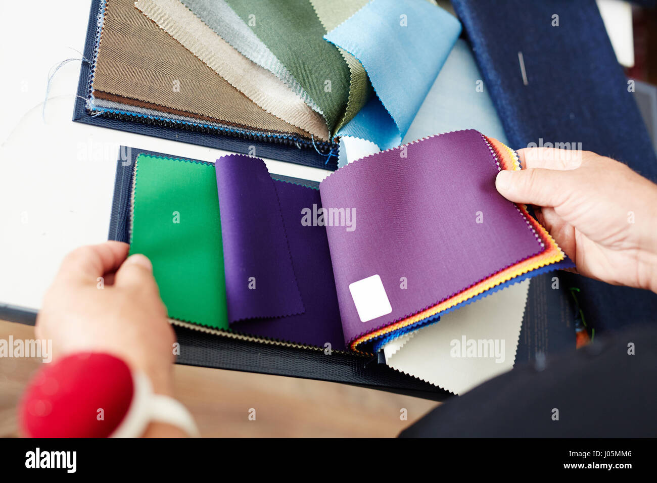 Tailor choosing textile and suitable color from samples Stock Photo - Alamy