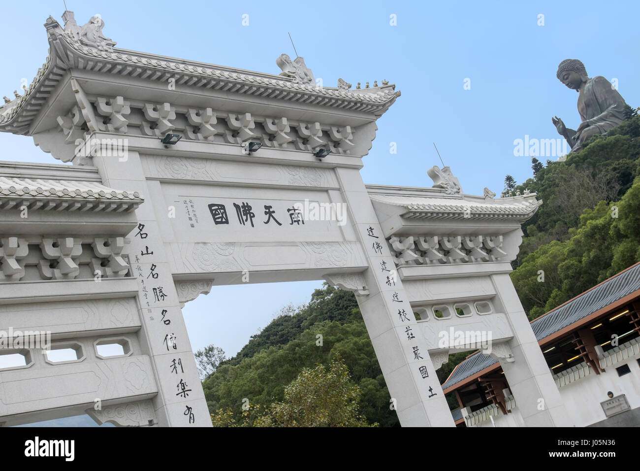 HONG KONG, LANTAU ISLAND, DEC 06 2015, Decorative gate with a view at a Buddha statue. Tian Tan Buddha on hill. Stock Photo