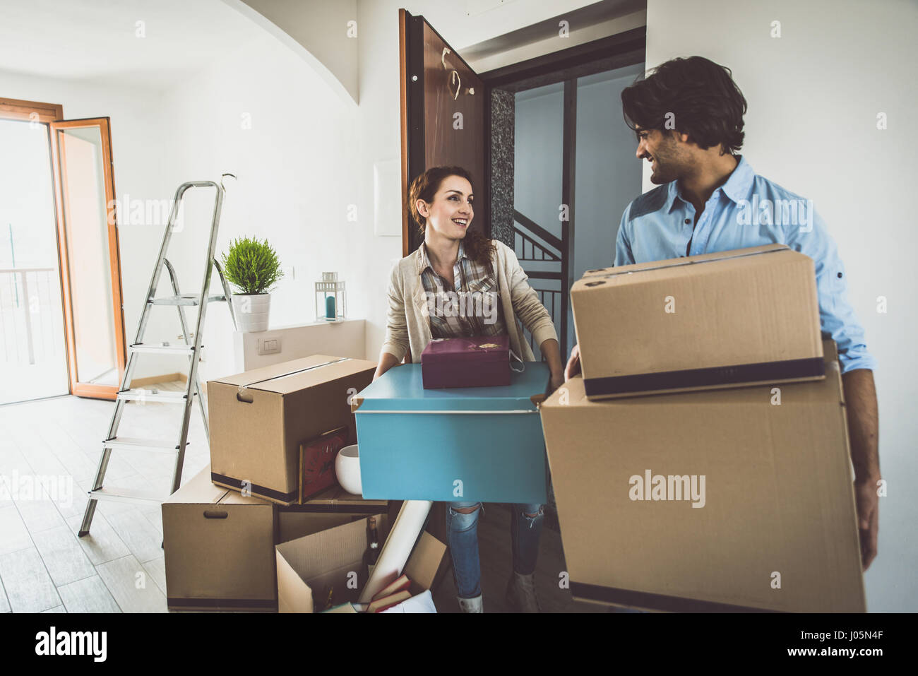 Young couple moving in into new apartment Stock Photo - Alamy