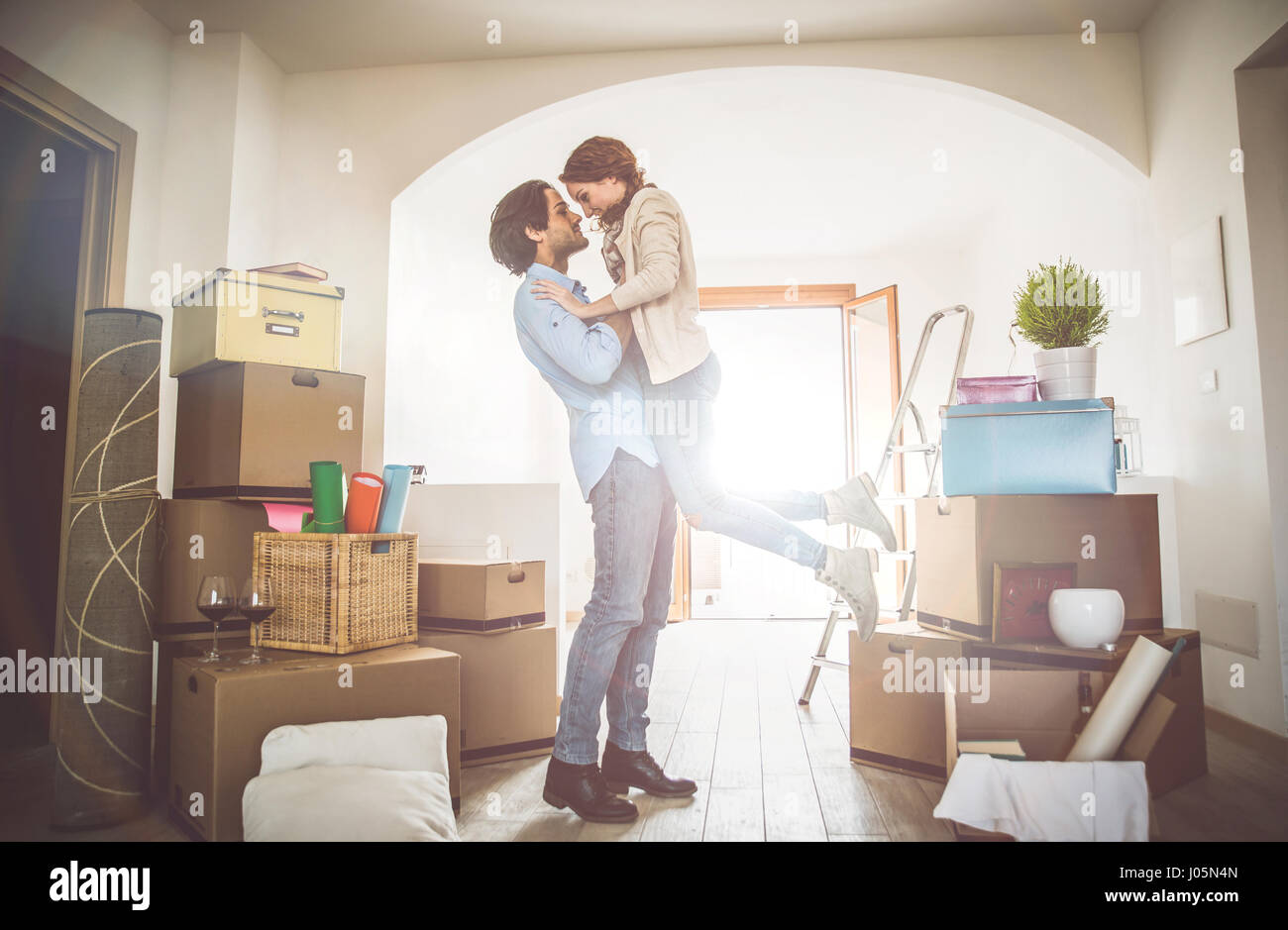Young couple moving in into new apartment Stock Photo