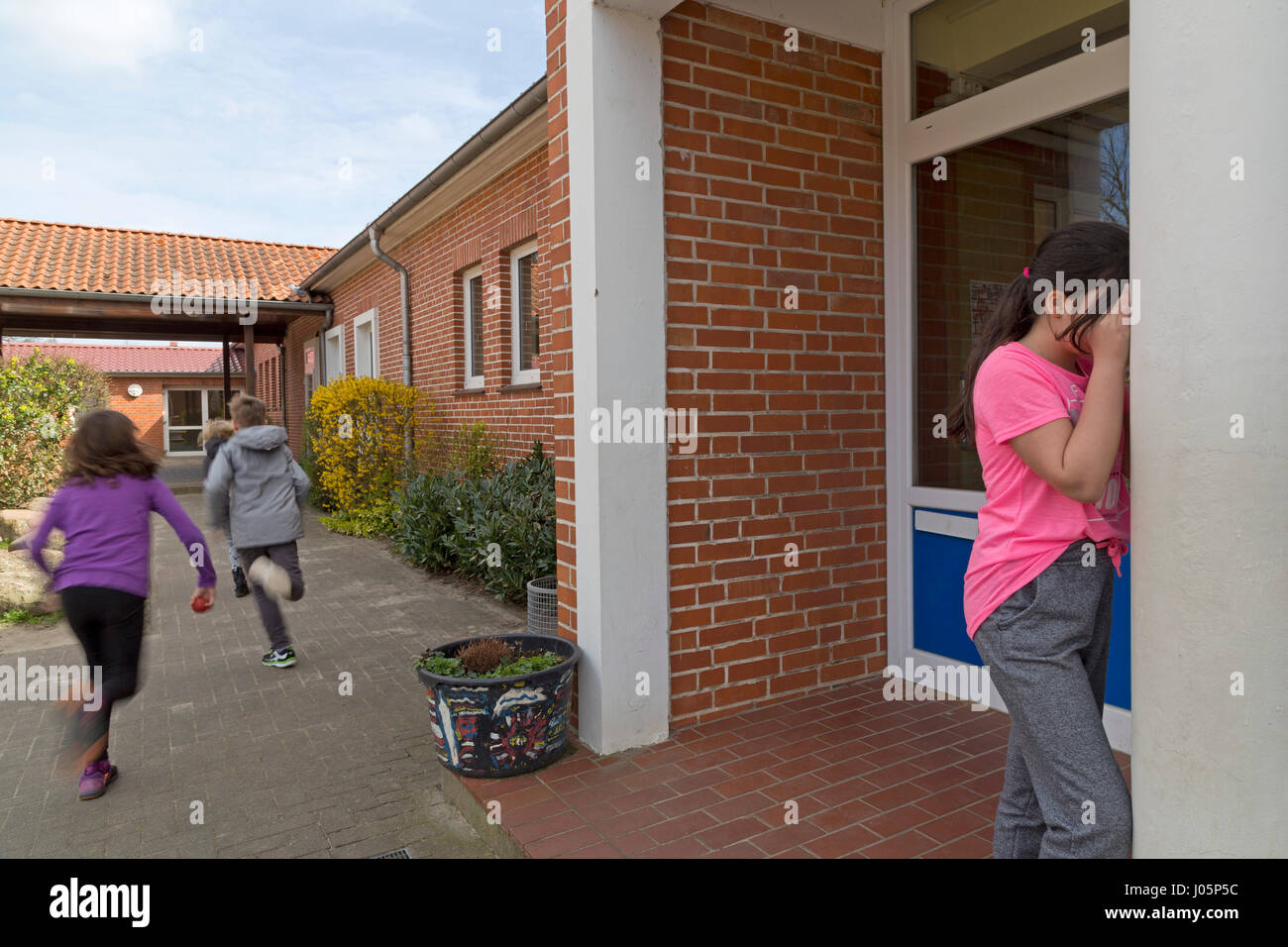 pupils at primary school playing hide and seek during break, Lower Saxony, Germany Stock Photo