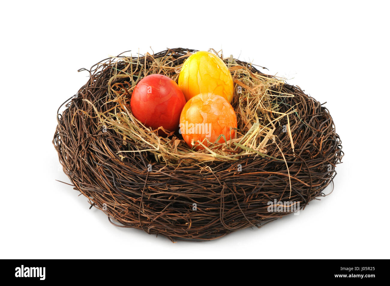 Easter eggs in nest on white isolated background Stock Photo - Alamy