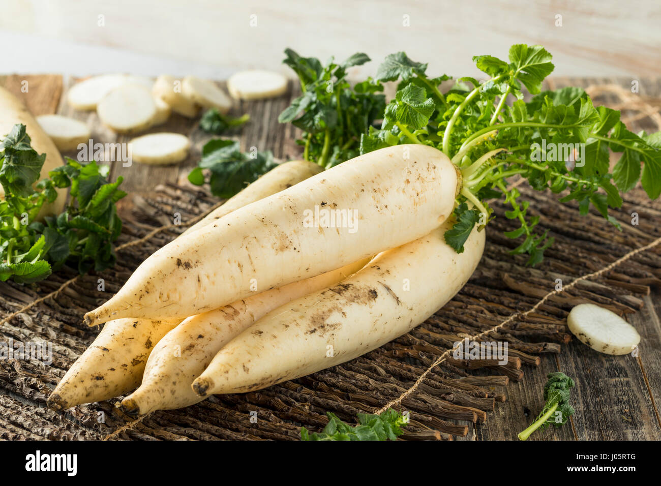 Raw Organic White Daikon with Green Leaves Stock Photo