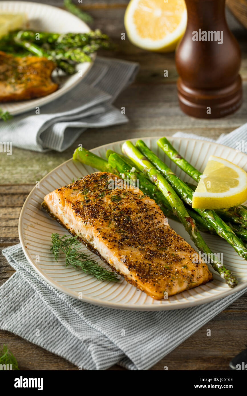 Organic Pan Seared Salmon with Lemon and Asparagus Stock Photo