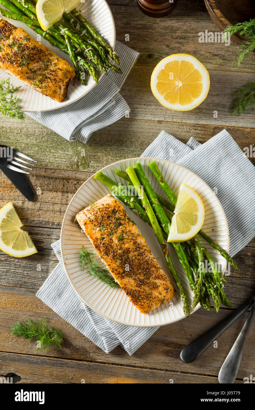 Organic Pan Seared Salmon with Lemon and Asparagus Stock Photo