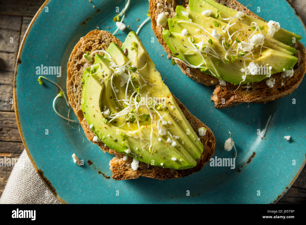 Healthy Homemade Avocado Toast with Cheese and Sprouts Stock Photo