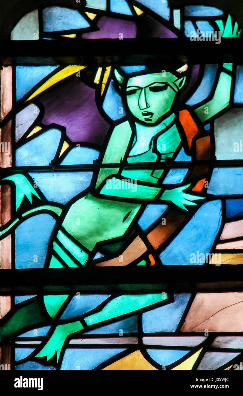 Stained Glass in the Church of Tervuren, Belgium, depicting a devil Stock Photo