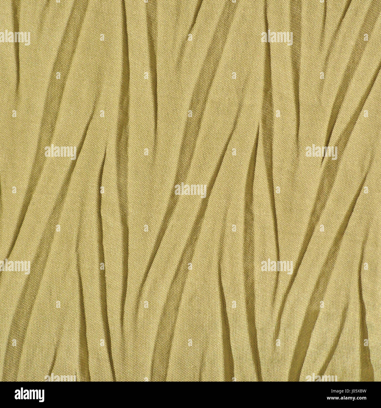 Yellow Golden Crumpled Synthetic textile, Creased Polyester Fabric Detail, Vertical Decorative Wrinkled Texture Pattern, Bright Large Detailed Texture Stock Photo