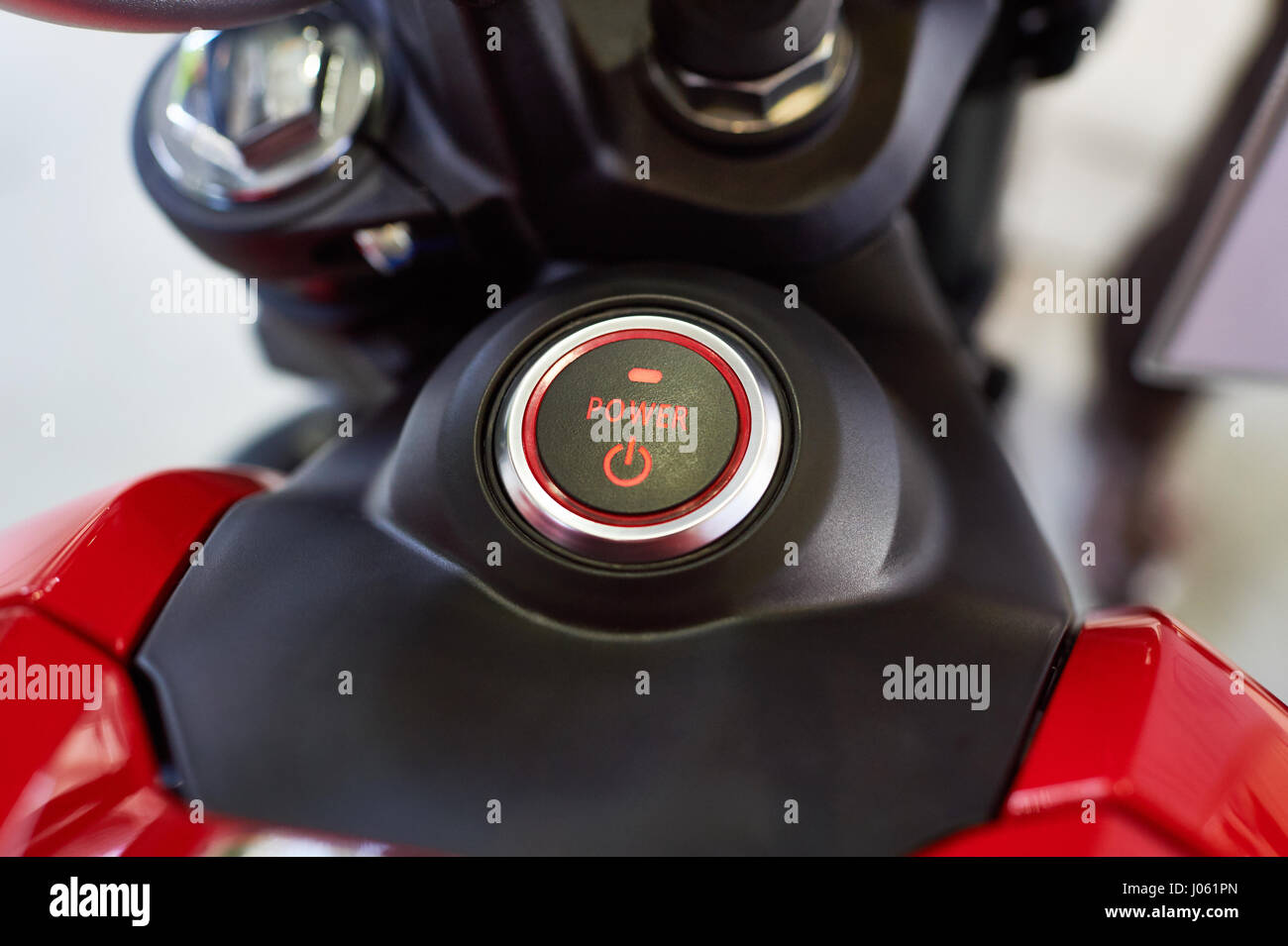 Button POWER on the instrument panel of electric motorcycle closeup Stock Photo