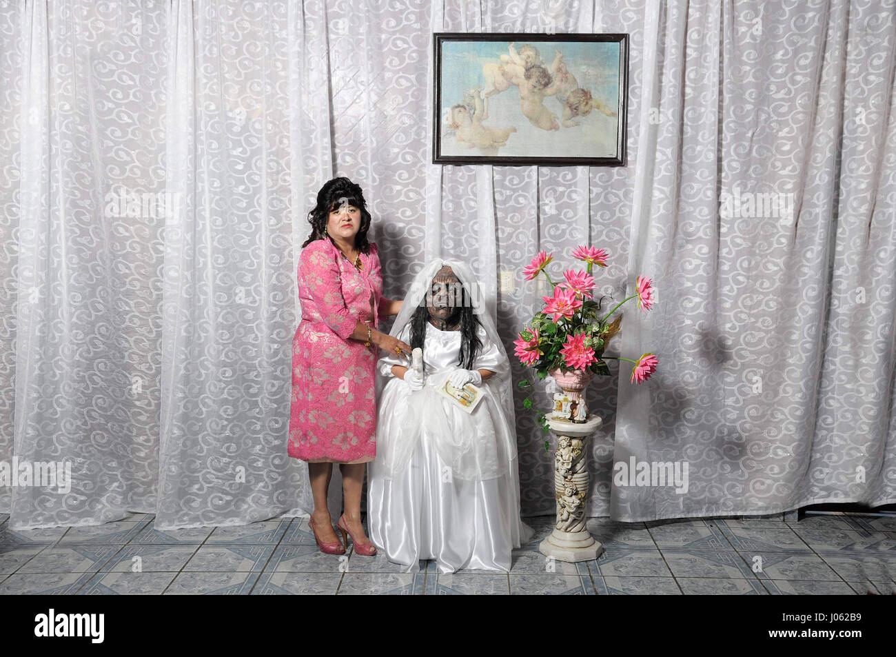 EYE-OPENING images recreate the monsters that haunt Mexicans who follow their traditional beliefs. The series of spectacular shots show large monsters dressed in flamboyant dresses and face masks watching television, at a birthday party and sitting in a workshop. One image even shows a monster dressed as a bride and one sitting on a bed underneath a crucifix. The photographs are the work of Mexican photographer Diego Moreno (24). To take the pictures, Diego used a Nikon D90 camera. Diego Moreno / mediadrumworld.com Stock Photo