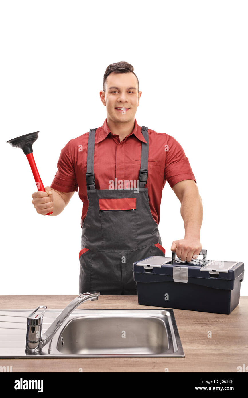 Plumber with a plunger and a toolbox standing behind a sink isolated on white background Stock Photo
