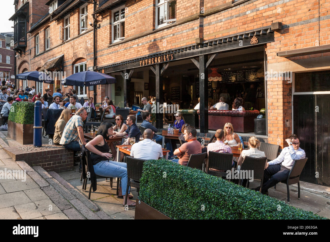 People sitting outside Fothergill's bistro restaurant and pub on a Summer evening in Nottingham city centre, England, UK Stock Photo
