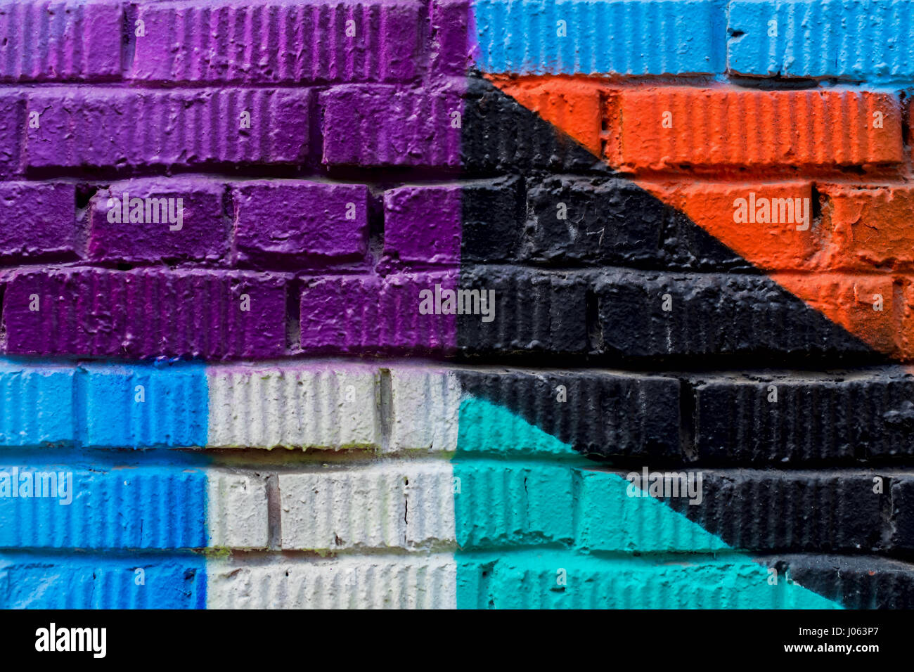 Brick wall with fragment of graffiti, abstract drawings art closeup. For background. Concept of