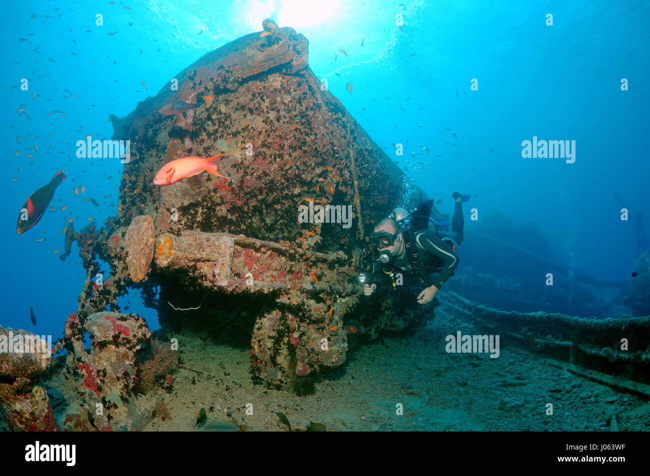 A diver swimming past a wrecked wagon. EERIE underwater pictures show inside the wreckage of the sunken British World War Two ship SS Thistlegorm on the seventy-fifth anniversary of her sinking. The series of images show the rusted remains of the merchant navy ship’s cargo which includes motorbikes, army trucks and an aircraft propeller. Other pictures show how sea life have been inhabiting the wreckage. Stock Photo
