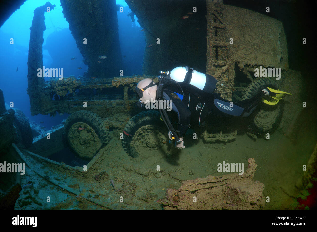 A diver swimming over to a truck. EERIE underwater pictures show inside the wreckage of the sunken British World War Two ship SS Thistlegorm on the seventy-fifth anniversary of her sinking. The series of images show the rusted remains of the merchant navy ship’s cargo which includes motorbikes, army trucks and an aircraft propeller. Other pictures show how sea life have been inhabiting the wreckage. Stock Photo