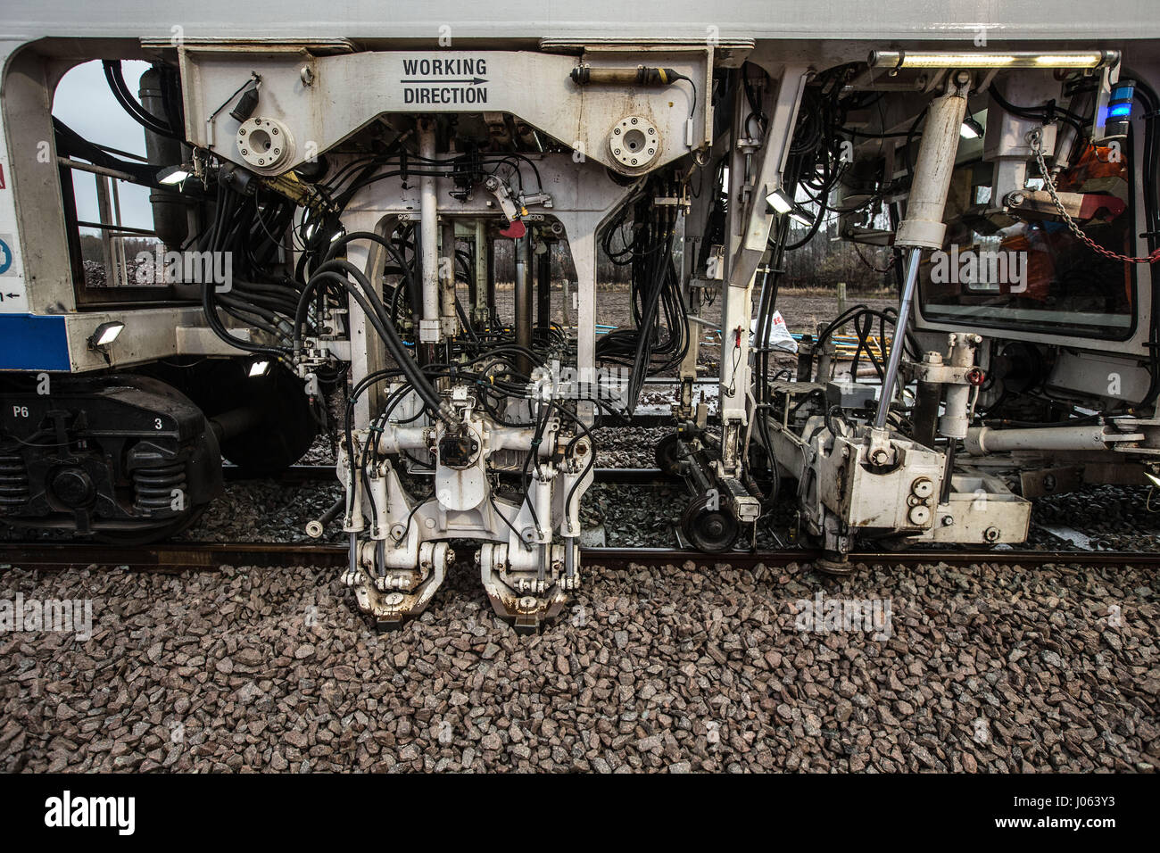 Rail workers laying new line and tamping train in Forres Scotland Stock