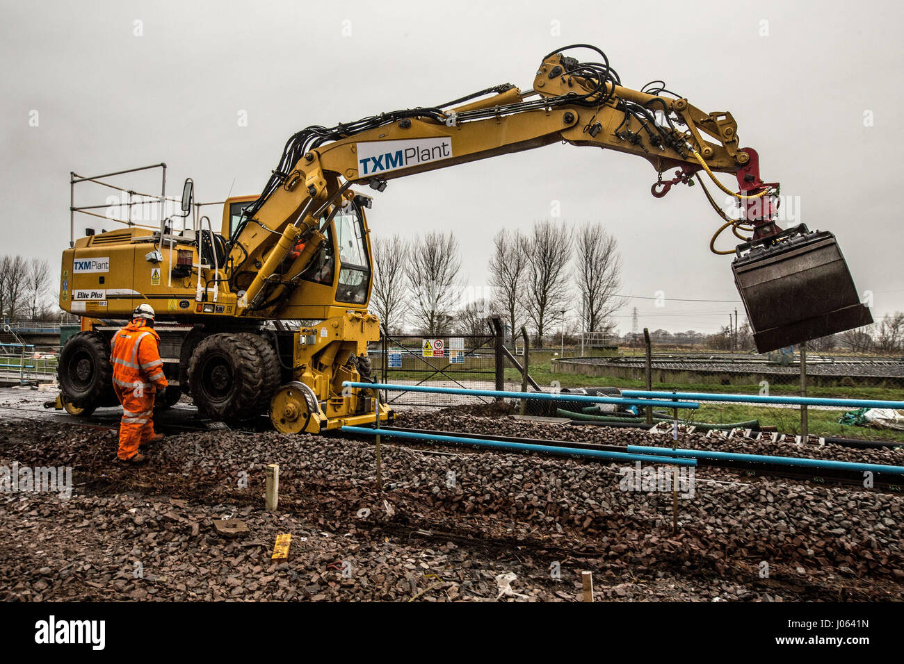 Rail workers spreading ballast and laying new line in Forres Scotland